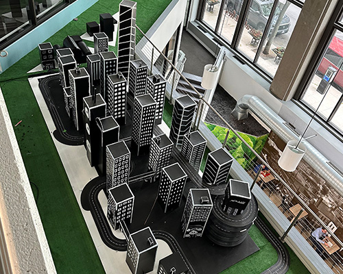 Overhead view of the art piece that features several buildings and roads in 4D.