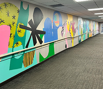 A painted wall full of shapes, textures and color.