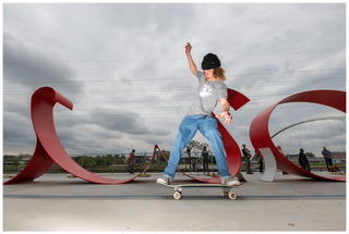 Skateboarder and Wow Sign