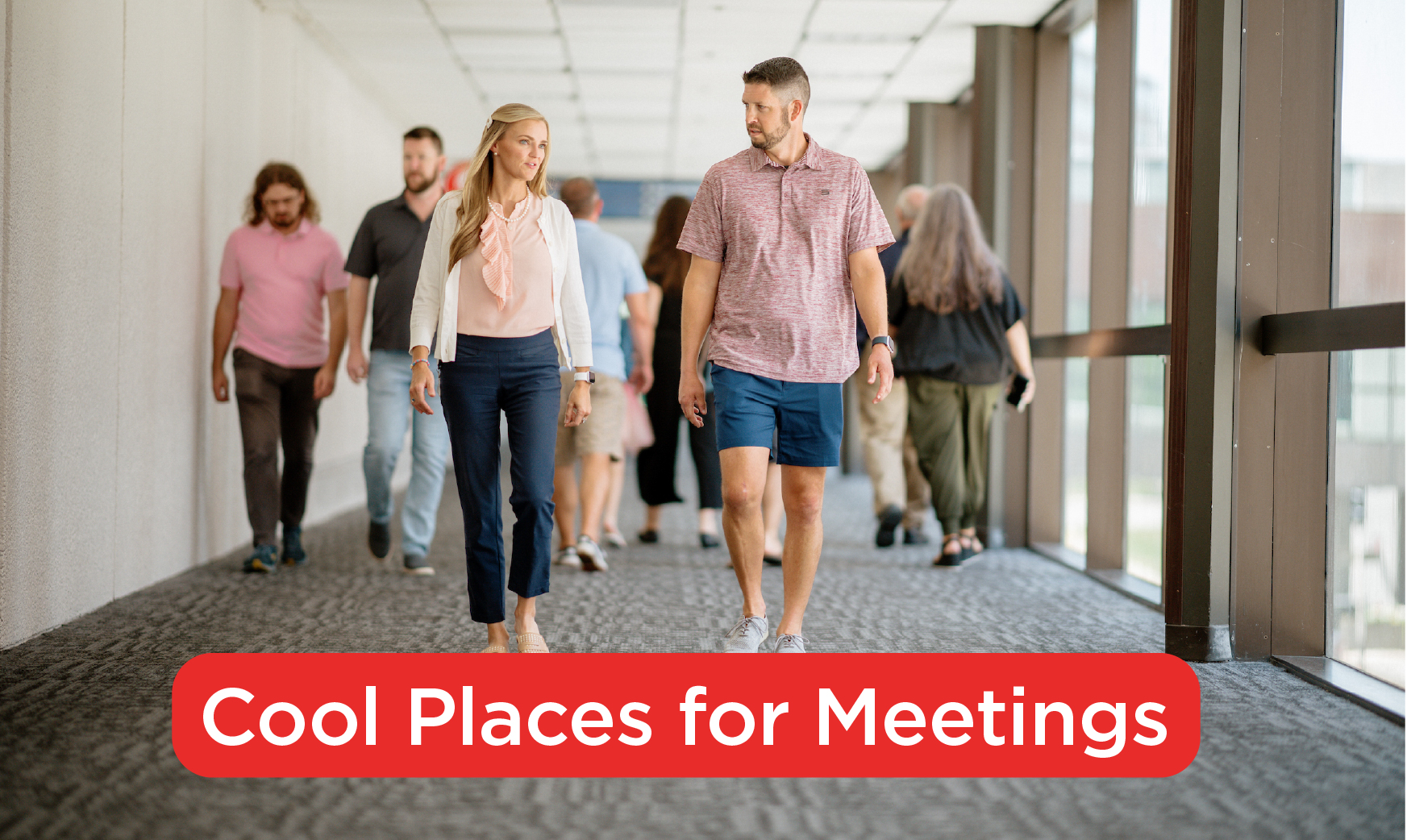 Several people walking in the skywalk with two in focus conversing. Text at the bottom of the page reads, Cool Places for Meetings