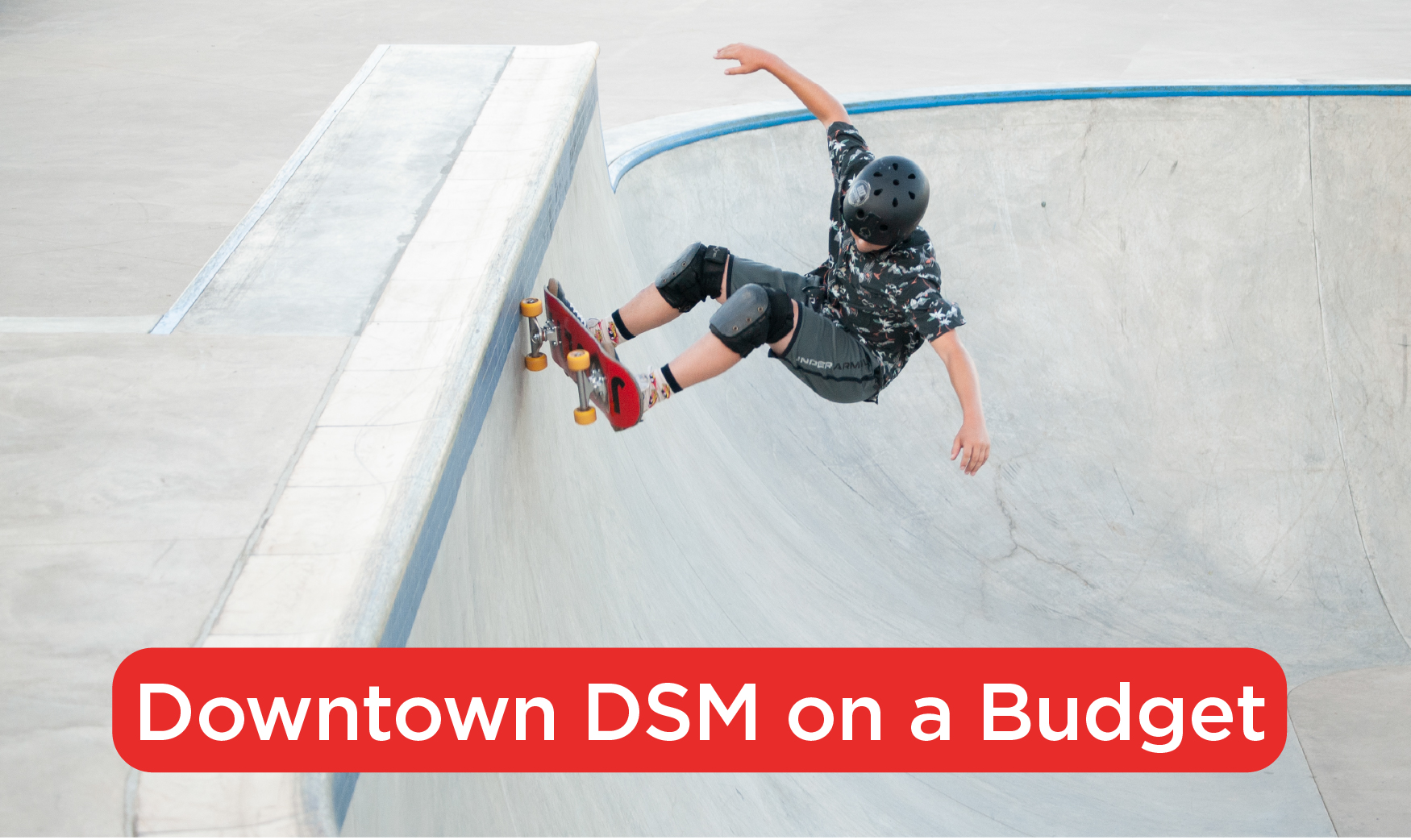A child on a skateboard at a skate park with text at the bottom of the photo that says Downtown DSM on a Budget