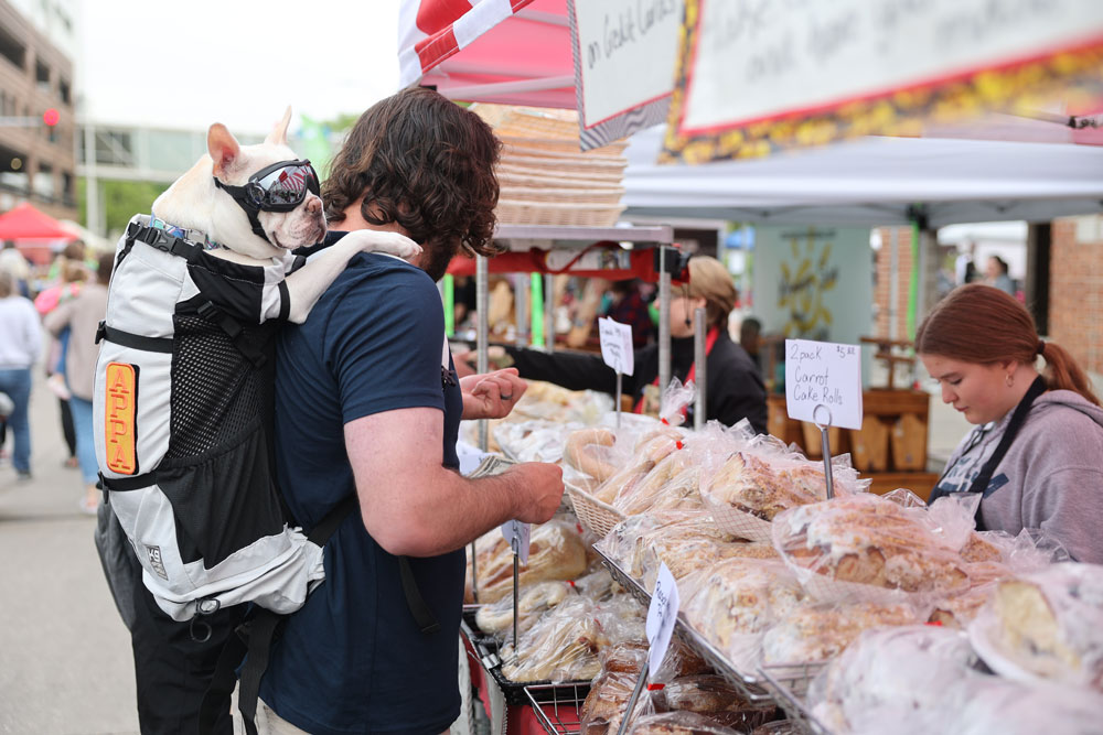 Downtown Farmers' Market booth man and dog at vendor booth