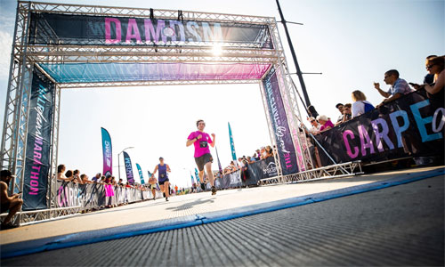 runners crossing DAM to DSM finish line