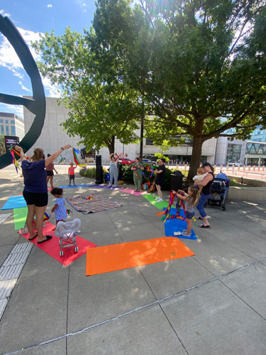 Storytime Under the Green Umbrella people at storytime in Downtown Des Moines