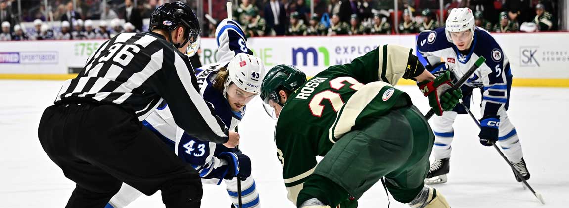 Iowa Wild players on the ice rink