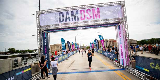 woman running across the finish line
