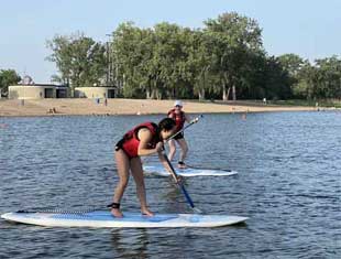 two people paddleboarding
