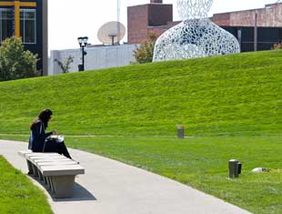 woman eating lunch at the Pappajohn Sculpture Park
