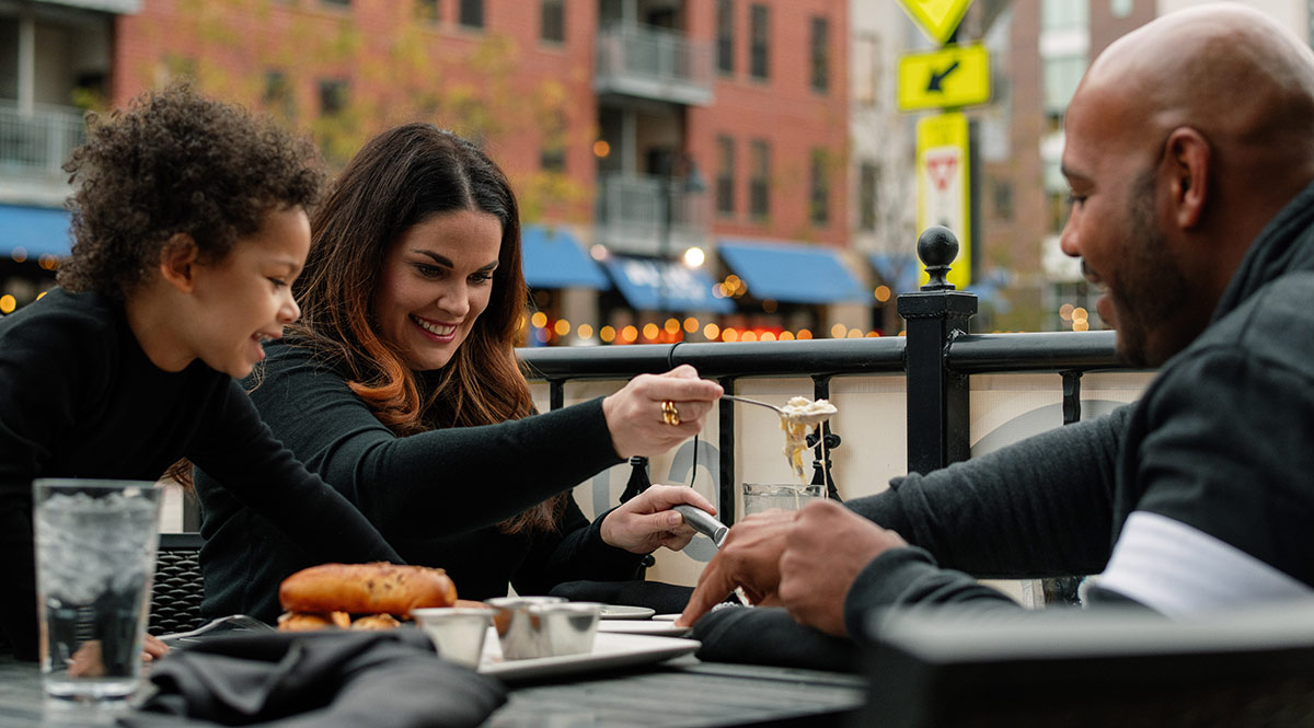 a family eating at a restaurant outside patio