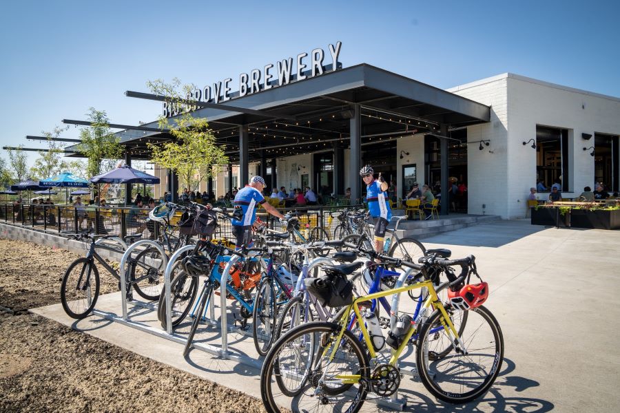 Bikes and two bikers in front of Big Grove Brewery