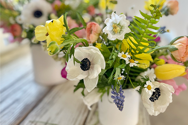 A floral arrangement in a pot displayed on a table