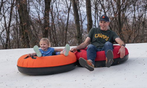 two people snowtubing