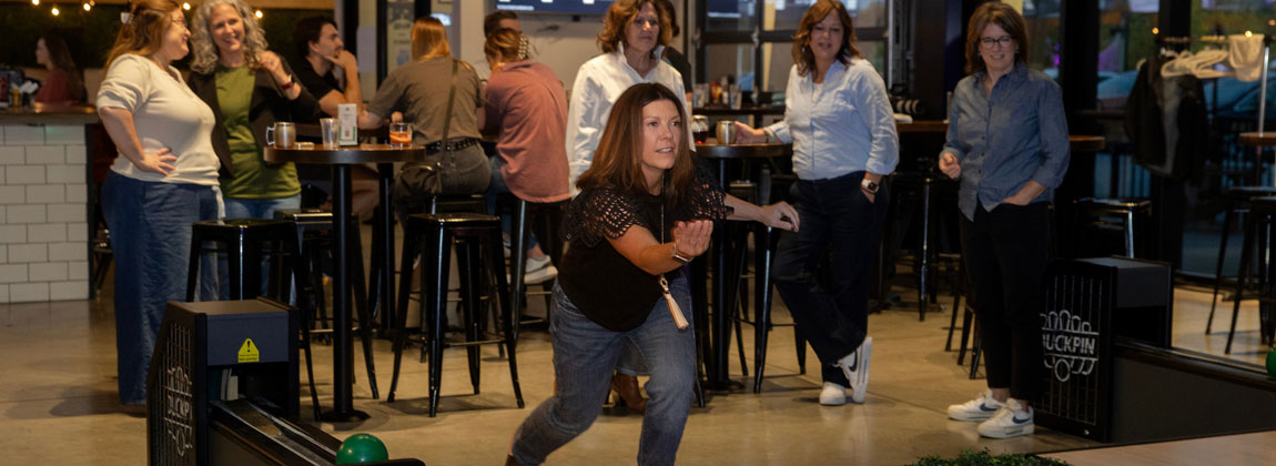 woman bowling with friends