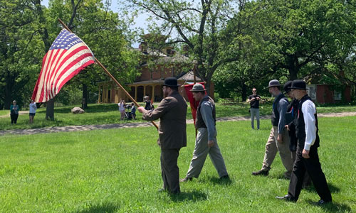 Living History Farms Memorial Day historical interpreters with U.S. flag