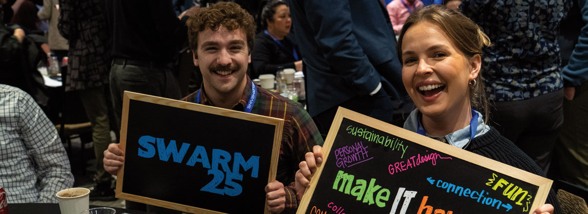 people holding Design Swarm 2025 signs