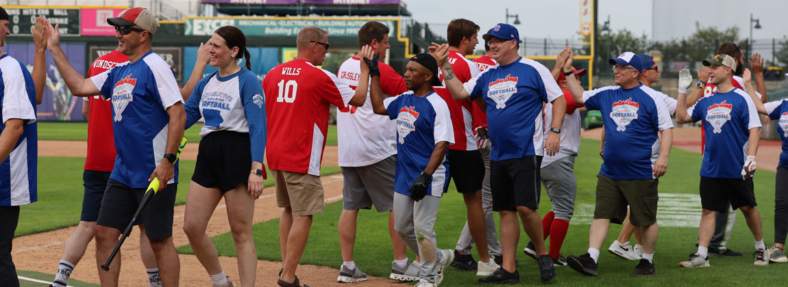 legislative softball players give high fives
