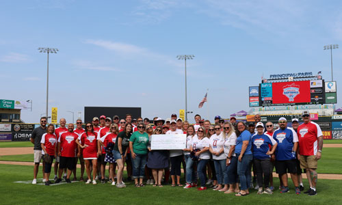 Legislative Softball Game all legislative softball players posing with big check
