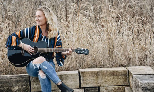 Kara Christensen playing guitar