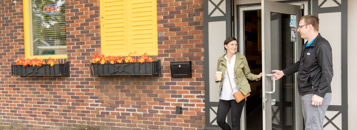 young person leaving coffee shop