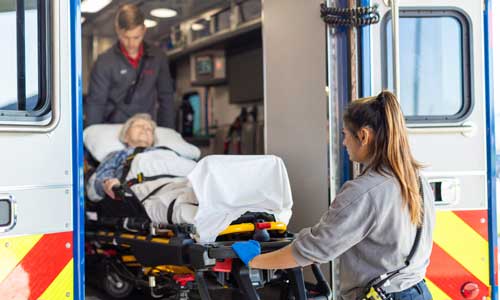 people at the back of an ambulance