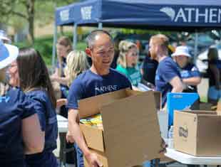 man carrying a box of books