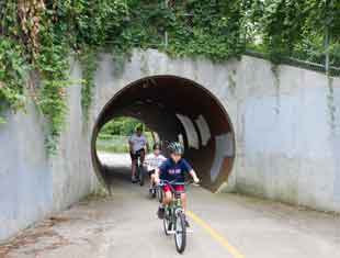 people riding bikes through Altoona, Iowa tunnel
