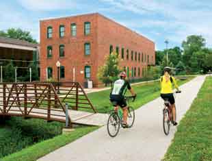 two people riding bikes on a trail