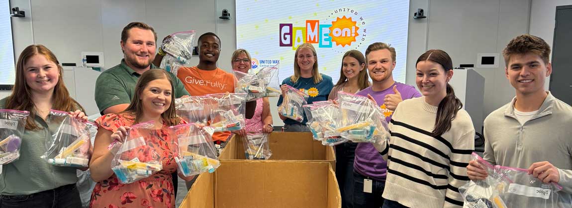 group posing with hygiene kits