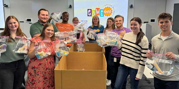 group posing with hygiene kits