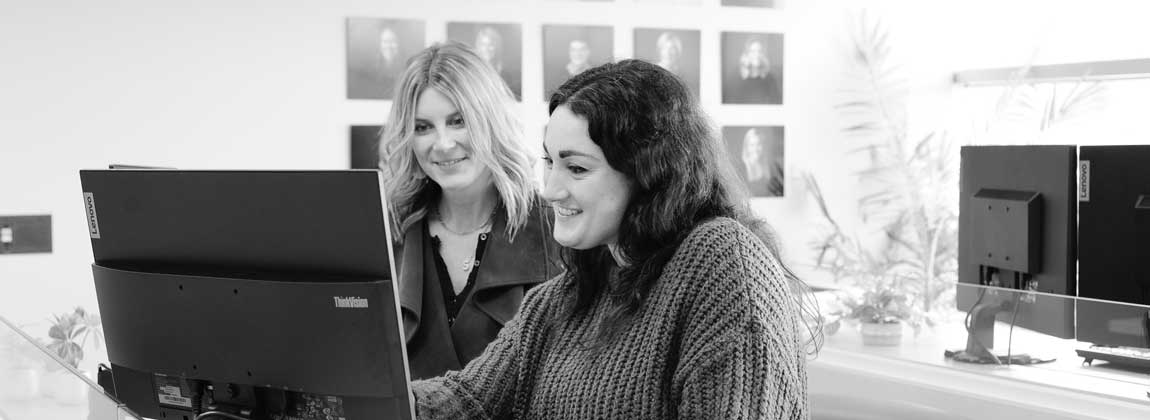 two people looking at a computer