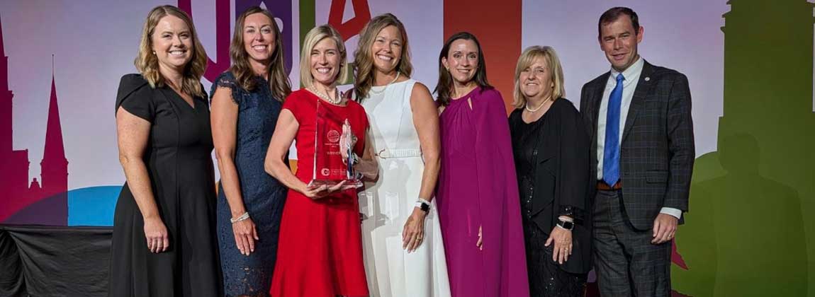 group posing with award