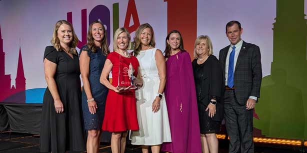 group posing with award