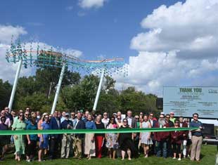 group of people at a ribbon cutting