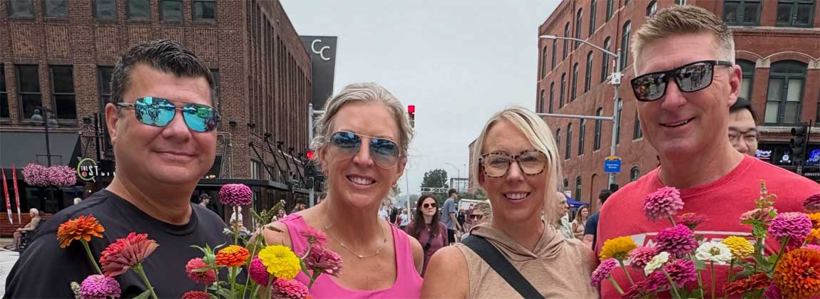 four people with flowers at The Market