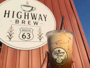 iced coffee in front of Highway Brew sign