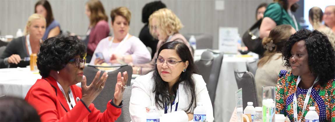three women talking at an event