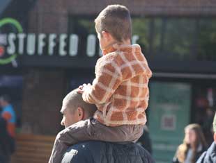 boy on man's shoulders at the Downtown Farmers' Market