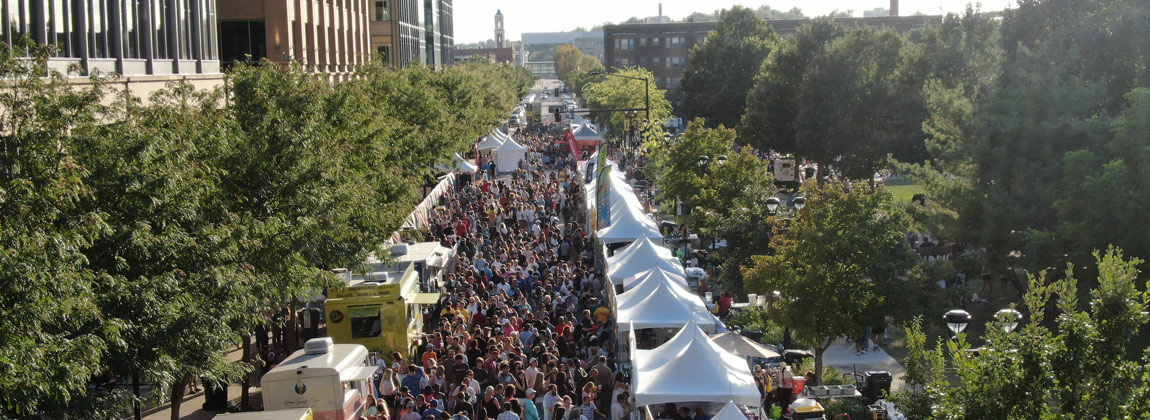 An overhead view of a street filled with people and vendors