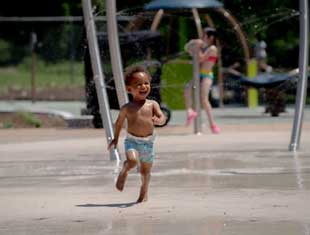 boy playing in Gray's Lake Sprayground