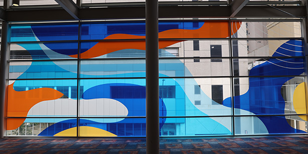 Windows covered in vinyl that are made of abstract shapes