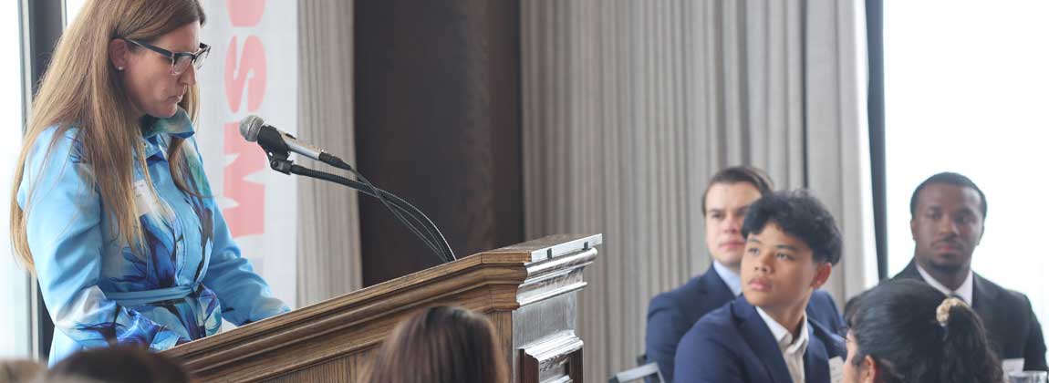woman speaking to interns