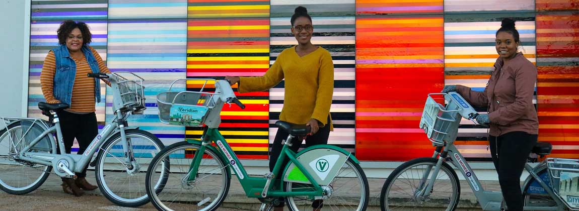 three women using BCycle