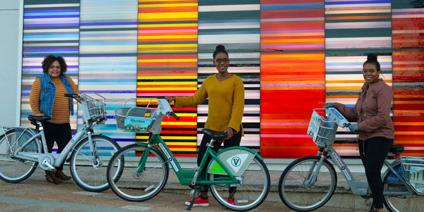 three women using BCycle