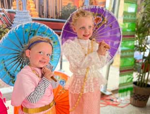 two children holding umbrellas
