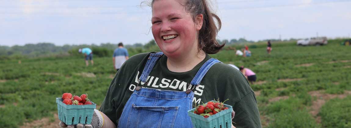woman holding strawberries