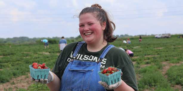 woman holding strawberries