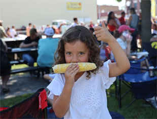 girl eating sweet corn