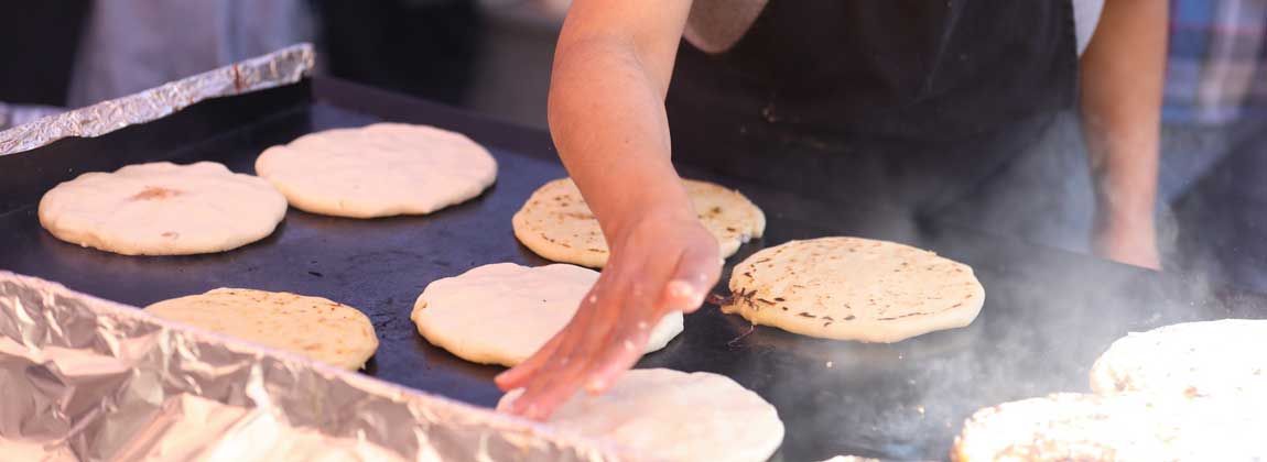 woman making pupusas
