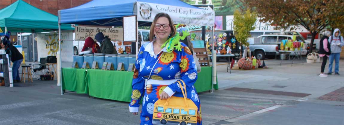 a woman wearing a Halloween costume at the Downtown Farmers' Market