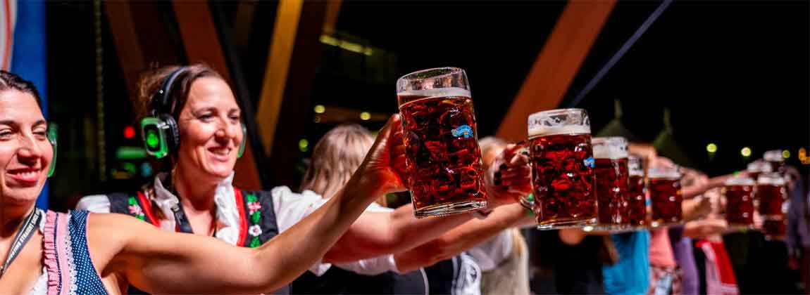 people holding up beer mugs